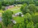 Aerial view of a home nestled amongst lush trees in a quiet neighborhood at 6900 Ridge Lane Rd, Charlotte, NC 28262