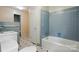 Classic bathroom featuring blue tile, a bathtub, a sink, and a toilet at 6900 Ridge Lane Rd, Charlotte, NC 28262