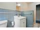 Bathroom with a white vanity and blue tile on the walls at 6900 Ridge Lane Rd, Charlotte, NC 28262
