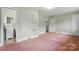 Spacious bedroom featuring pink carpet, light green walls, and direct bathroom access at 6900 Ridge Lane Rd, Charlotte, NC 28262