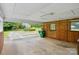 Spacious carport with wood paneled walls and concrete flooring provides ample covered parking at 6900 Ridge Lane Rd, Charlotte, NC 28262