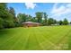Expansive green lawn surrounds this well-maintained brick home, offering plenty of space for outdoor activities at 6900 Ridge Lane Rd, Charlotte, NC 28262