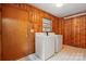 Utility room featuring wood paneling and a washer and dryer at 6900 Ridge Lane Rd, Charlotte, NC 28262