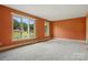 Well lit, comfortable living room featuring fresh carpet and large windows with pleasant views at 6900 Ridge Lane Rd, Charlotte, NC 28262