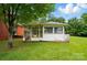 Exterior view of sunroom featuring windows and access to the backyard at 6900 Ridge Lane Rd, Charlotte, NC 28262