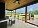 Covered back porch with wooded ceiling, metal railing and view of the expansive backyard at 7133 Church Rd, Taylorsville, NC 28681