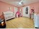 Cozy Bedroom with pink walls, white crib, decorative touches and ample natural light at 7133 Church Rd, Taylorsville, NC 28681