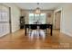 Well-lit dining room with a modern black table and seating for six with vinyl flooring at 7133 Church Rd, Taylorsville, NC 28681