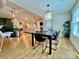 Open-concept dining room with a modern pendant light and views into the living room and kitchen at 7133 Church Rd, Taylorsville, NC 28681