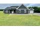 Charming home with dark siding, white trim, and a well-manicured lawn at 7133 Church Rd, Taylorsville, NC 28681