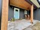Charming front porch featuring rocking chairs and a bright blue front door at 7133 Church Rd, Taylorsville, NC 28681