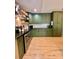 Well-lit kitchen with lots of cabinet space, stainless steel appliances, and wooden floating shelves at 7133 Church Rd, Taylorsville, NC 28681