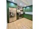 Modern kitchen features stainless steel appliances, and green cabinets with plenty of storage space at 7133 Church Rd, Taylorsville, NC 28681