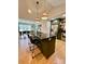 A spacious kitchen island has granite countertops and seating for two with views to dining room at 7133 Church Rd, Taylorsville, NC 28681