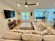 Spacious living room features a large sectional sofa, ceiling fan, and a view into the dining room at 7133 Church Rd, Taylorsville, NC 28681