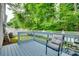 Fenced backyard featuring a deck with patio chairs, overlooking lush trees at 727 Torrey Pines Ln, Fort Mill, SC 29715