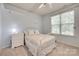 Bright bedroom featuring a ceiling fan and a window with blinds, creating a cozy atmosphere at 727 Torrey Pines Ln, Fort Mill, SC 29715
