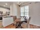 Cozy dining area with hardwood floors, a modern light fixture, and views of the backyard at 727 Torrey Pines Ln, Fort Mill, SC 29715