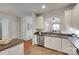 Bright kitchen features stainless steel appliances, white cabinets, and an open layout to the living area at 727 Torrey Pines Ln, Fort Mill, SC 29715