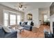 Bright living room with hardwood floors, ceiling fan, and comfortable blue sofas at 727 Torrey Pines Ln, Fort Mill, SC 29715