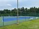 Outdoor tennis courts are enclosed by a fence with benches available for players at 727 Torrey Pines Ln, Fort Mill, SC 29715