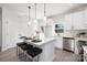 Modern kitchen featuring a central island with seating, stainless steel appliances, and white cabinetry at 7805 Shadow Lawn Rd, Charlotte, NC 28269