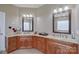 Elegant bathroom with double sinks, granite countertops, and ample cabinet space at 8409 Olde Stonegate Ln, Mint Hill, NC 28227