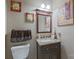 Cozy powder room with granite vanity and decorative artwork on the walls at 8409 Olde Stonegate Ln, Mint Hill, NC 28227