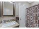 Bathroom featuring a granite countertop sink, framed mirror, and a decorative shower curtain at 8409 Olde Stonegate Ln, Mint Hill, NC 28227