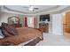 A beautifully appointed primary bedroom with a large TV, fireplace, and adjoining bathroom for ultimate comfort at 8409 Olde Stonegate Ln, Mint Hill, NC 28227