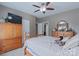 Comfortable bedroom featuring a ceiling fan, wardrobe, and a classic wooden bed frame at 8409 Olde Stonegate Ln, Mint Hill, NC 28227