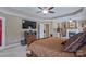 Spacious bedroom boasts a trey ceiling, ceiling fan and fireplace, perfect for relaxing and unwinding at 8409 Olde Stonegate Ln, Mint Hill, NC 28227