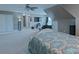 Spacious carpeted bedroom featuring a ceiling fan and a television over some storage at 8409 Olde Stonegate Ln, Mint Hill, NC 28227