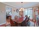 Traditional dining room with a wooden table, chandelier, and ample seating at 8409 Olde Stonegate Ln, Mint Hill, NC 28227