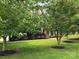 Well-manicured lawn and landscaping highlight this stately brick home's curb appeal at 8409 Olde Stonegate Ln, Mint Hill, NC 28227