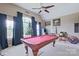 Spacious game room with a pool table, large windows, and a ceiling fan at 8409 Olde Stonegate Ln, Mint Hill, NC 28227