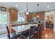 The kitchen offers a center island, stainless steel appliances, and hardwood flooring at 8409 Olde Stonegate Ln, Mint Hill, NC 28227