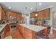 Spacious kitchen with stainless steel appliances, custom cabinets, a large island, and wood flooring at 8409 Olde Stonegate Ln, Mint Hill, NC 28227