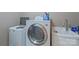Practical laundry room with washer, dryer, utility sink and cleaning supplies at 8409 Olde Stonegate Ln, Mint Hill, NC 28227