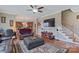 Spacious living room with hardwood floors, large TV, and an open floor plan to the kitchen at 8409 Olde Stonegate Ln, Mint Hill, NC 28227