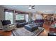 Comfortable living room featuring hardwood floors, large windows, and a stylish area rug at 8409 Olde Stonegate Ln, Mint Hill, NC 28227