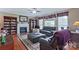 Inviting living room with a fireplace, built-in bookshelves, and a comfortable seating area for relaxation at 8409 Olde Stonegate Ln, Mint Hill, NC 28227