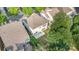 An aerial view showcases a home with a patio and backyard in a wooded neighborhood with neighboring houses nearby at 9429 Ridgeforest Dr, Charlotte, NC 28277
