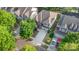 An aerial view shows a charming two-story home, a basketball hoop, and a well-manicured lawn with mature trees at 9429 Ridgeforest Dr, Charlotte, NC 28277
