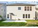Exterior view of the home's rear facade, featuring a door leading to the backyard and classic white siding at 9429 Ridgeforest Dr, Charlotte, NC 28277