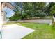A spacious backyard features a concrete patio and a terraced garden with a retaining wall and white picket fence at 9429 Ridgeforest Dr, Charlotte, NC 28277