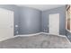 Another view of the bedroom showing plush carpets and two doors at 9429 Ridgeforest Dr, Charlotte, NC 28277