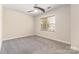 Spacious bedroom featuring neutral carpeting, ample lighting, and a bright window at 9429 Ridgeforest Dr, Charlotte, NC 28277