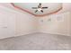 Spacious bedroom with tray ceiling, ceiling fan, carpet, and windows at 9429 Ridgeforest Dr, Charlotte, NC 28277