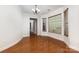 Formal dining area with hardwood floors, large bay window, and chandelier lighting, perfect for entertaining guests at 9429 Ridgeforest Dr, Charlotte, NC 28277